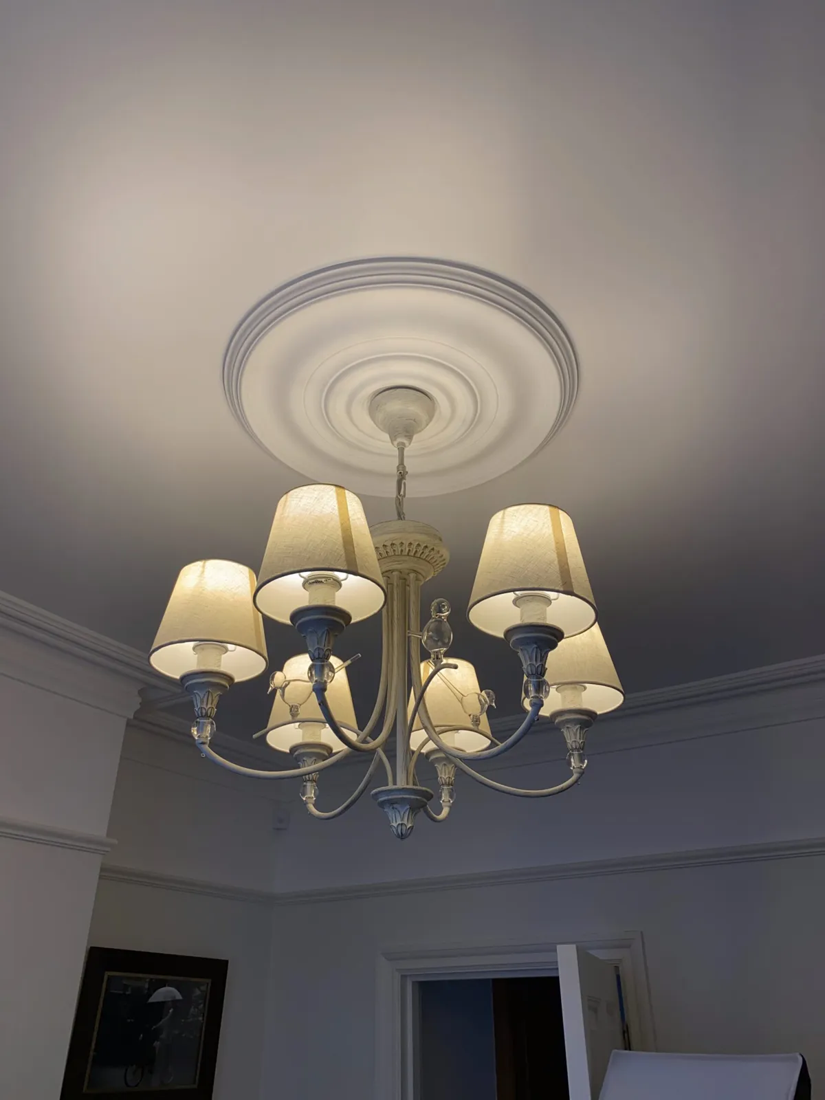 Restored ceiling rose and chandelier in a period home after electrical work