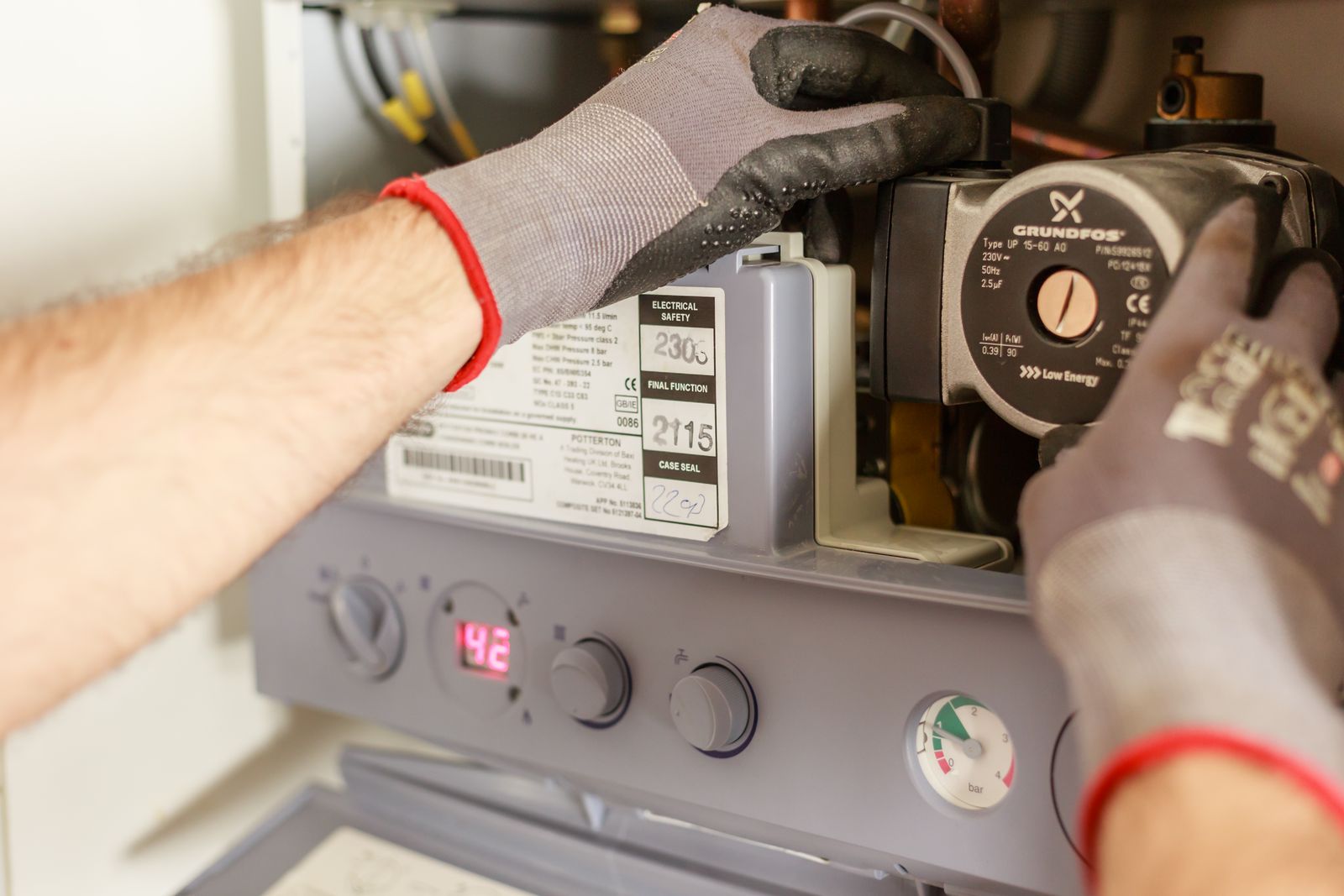 Real boiler servicing photograph showing work on the internal heating pump